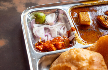 onion and pickle served with Aalo sabzi