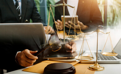 Justice and law concept.Male judge in a courtroom with the gavel, working with, computer and...
