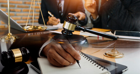 Justice and law concept.Male judge in a courtroom with the gavel, working with, computer and...