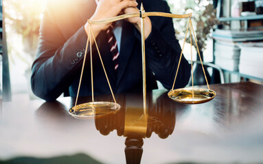 Justice and law concept.Male judge in a courtroom with the gavel, working with, computer and...