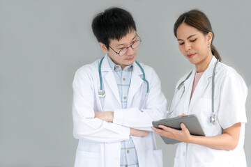 Fototapeta premium Team of doctors consults about patients by tablet for Telemedicine treatment.