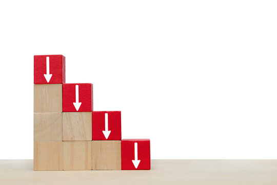 Arrow pointing down on red wooden block.  Symbol of the fall of investment or businesses 