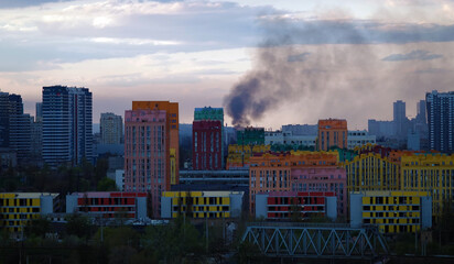Fire and smoke on the background of city buildings