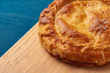 Apple pie on a wooden board close up