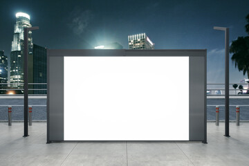 Empty white bus stop billboard on blurry night city background. Commercial and ad concept. Mock up, 3D Rendering.