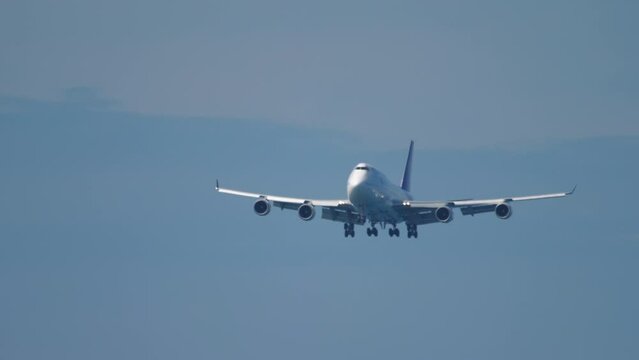 Wide body airliner descending for landing at Phuket Airport. Passenger jumbo jet flies. Tourism and travel concept