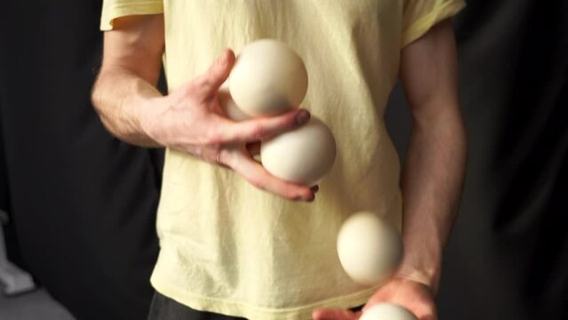 juggler with balls, throw balls from hand to hand, guy juggles, professional circus artist