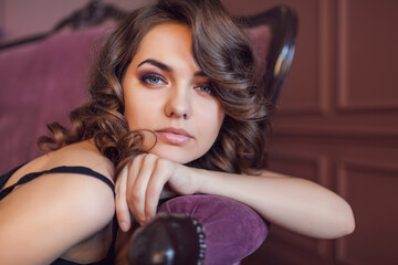 Fototapeta premium Beautiful woman in a luxurious retro interior in a black dress