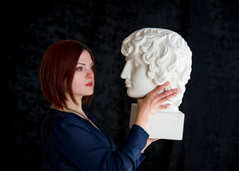 portrait of beautiful woman with bust monument of  on black background. legends of ancient greece. statue of dionysus