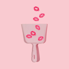 Valentines day creative layout with red lips kiss print in dustpan on pastel pink background. 80s...