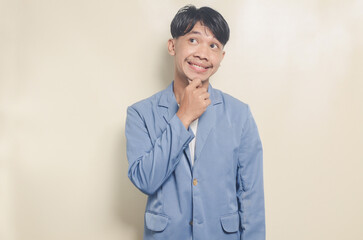 young asian man wearing college suit with serious thinking expression on isolated background