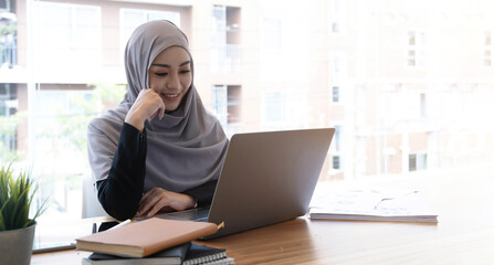 Happy beautiful muslim business woman brown hijab working about financial with business report and...