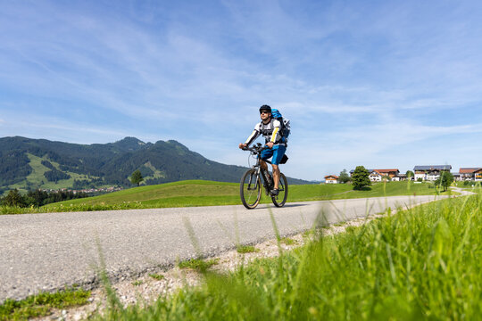 Cyclist on a bike tour in the southern Bavarian mountains