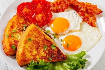 irish breakfast of fried eggs, bacon, potato farls