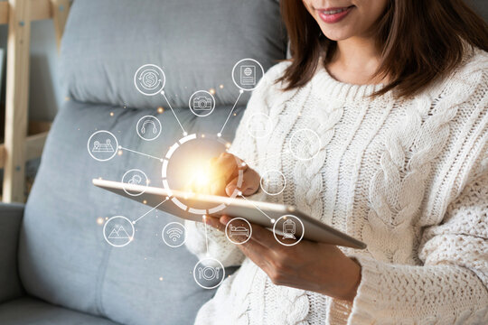 Hands of Asian girl using tablet at home. Woman are search on the internet for travel information.