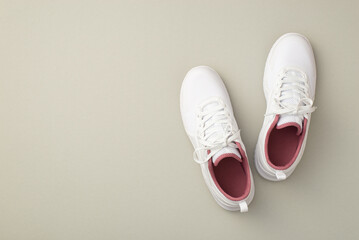 Sports concept. Top view photo of white sneakers on isolated pastel grey background