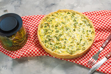 Traditional french homemade onion pie or quiche on concrete table