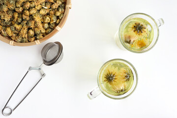 Chrysanthemum flower tea and dried chrysanthemum buds on white background. healthy beverage concept.