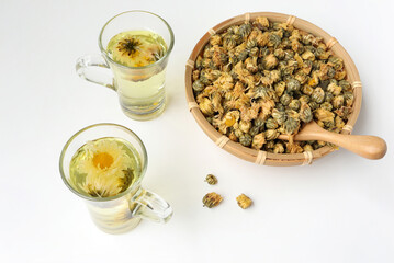 Chrysanthemum flower tea and dried chrysanthemum buds on white background. healthy beverage concept.