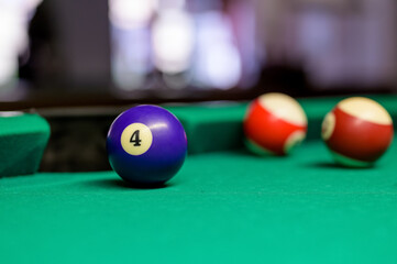 ball number 4 stands in front of pocket. billiard game in the club. snooker,