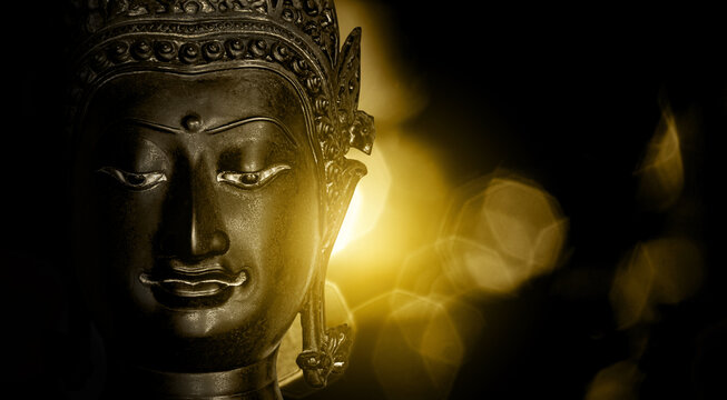 Buddha statue made of gold bronze on natural background