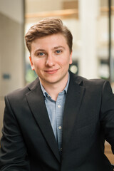 Fototapeta premium Young attractive businessman lawyer in a suit. Video conference, call, profile picture, handsome businessman portrait, professional profession, person concept