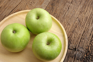 Green apples. Fresh ripe green apple on wooden plate.