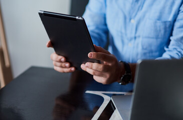 Close up shot of hands using a tablet.
