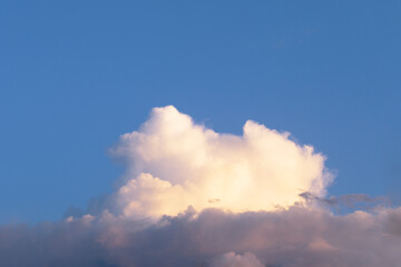 Big white fluffy clouds in clear blue sky. Summer background. Perspective, horizon.