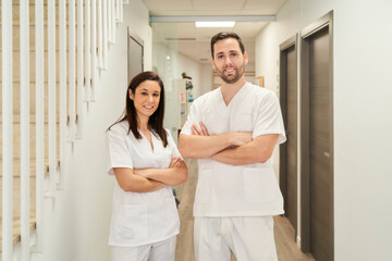 portrait of two physiotherapists in their clinic looking at the camera