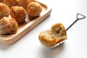 Sliced banana cake with spoon on a white background. delicious banana soft cupcake on a wooden plate.