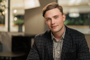 Naklejka premium Young attractive businessman lawyer in a suit. Video conference, call, profile picture, handsome businessman portrait, professional profession, person concept