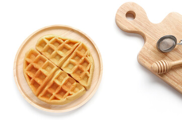Belgian waffles on wooden plate for breakfast. Delicious homemade pastry, top view,Copy space.