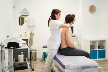 a man being treated for a spinal cord injury at the physiotherapist's office