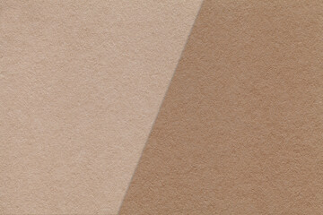 Texture of craft beige and brown paper background, half two colors, macro. Structure of vintage craft cardboard.