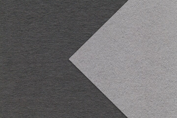 Fototapeta premium Texture of gray and black paper background, half two colors with arrow, macro. Structure of dense craft grey cardboard.