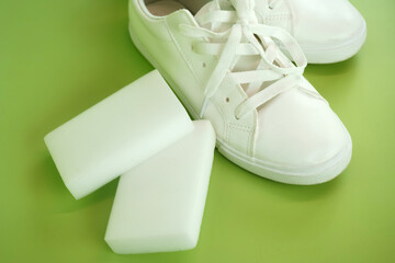 Melamine sponge and a pair of white sneakers. Shoe shine
