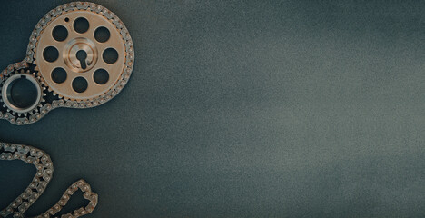 Gears from a car engine and a chain on a dark background. Poster, copy space