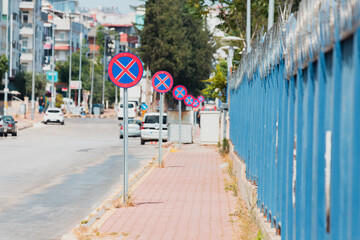 Many Road signs prohibiting parking and stopping. Traffic laws and urban development