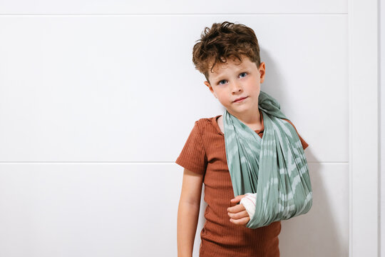 Little boy with broken arm in sling