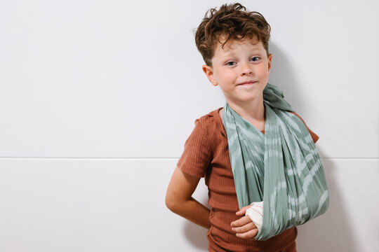 Little boy with broken arm in sling