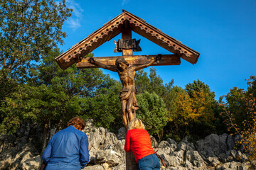 Pilgrims at the foot of the crucifix on top of the hill of apparitions, Podbrdo, Medjugorje, Bosnia...