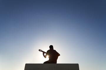 Anonymous man playing guitar on street