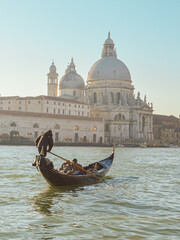 Gondolier rowing on the Grand Canal in winter, Venice, Italy