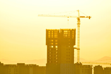 construction site with crane in sunrise