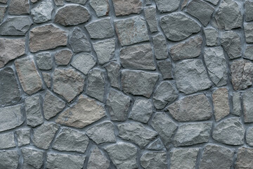 Gray stone wall background, great design for any purposes. Natural stonewall. Grunge rock texture. Grey floor surface. Cobblestones backdrop. Building facade.