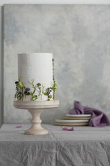 White wedding cake with lillac and green flowers