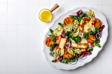 Grilled apricot and zucchini salad with halloumi and mustard dressing. Fresh summer gourmet salad on white background