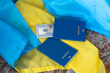 Flag of Ukraine, passport and banknotes of the national currency, on a green background, top view, flatly, the concept of travel preparation, tourism, vacation trip.