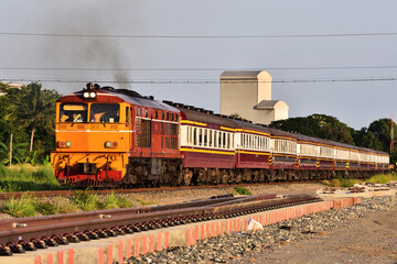 Obraz premium Passenger train on the railway (Building in background is public's)